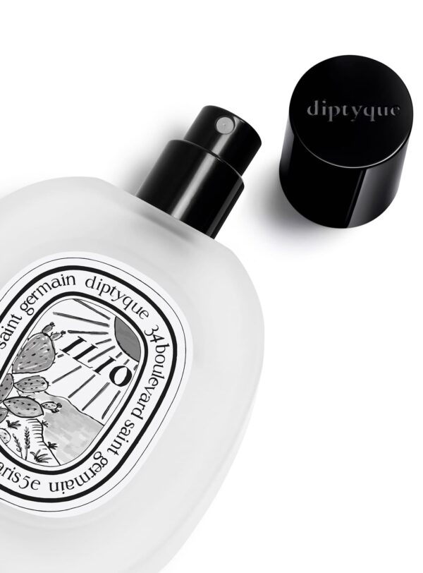Frasco abierto del Hair Mist Ilio de Diptyque con vaporizador negro, detalle del diseño gráfico, colección verano 2025.