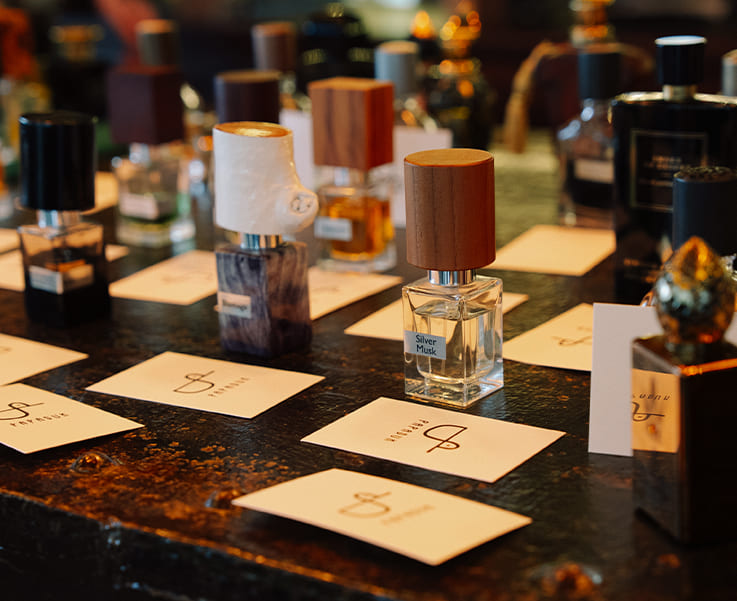 Selection of niche perfumes on a table at Papaduk Ibiza, a fragrance discovery experience